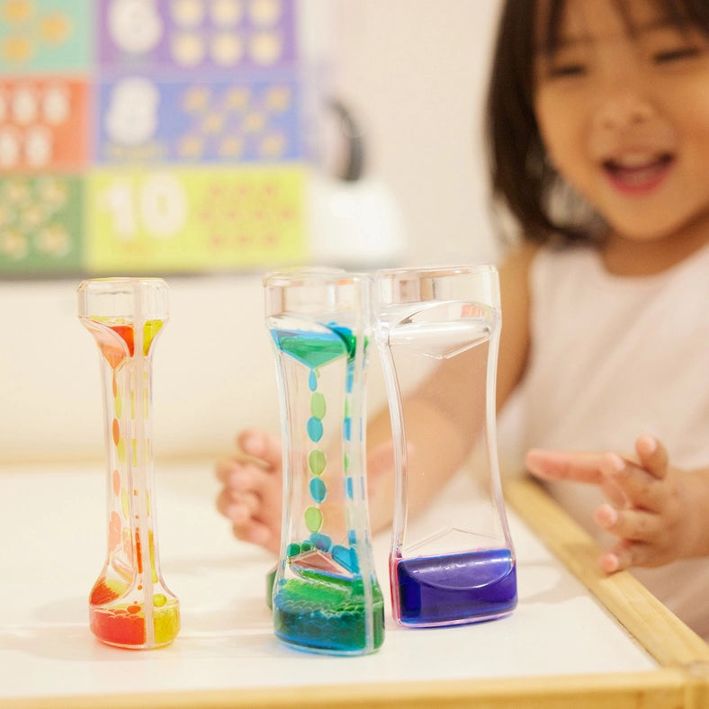 Buntes Liquid Motion Spiel 5er Set - Kind im Hintergrund