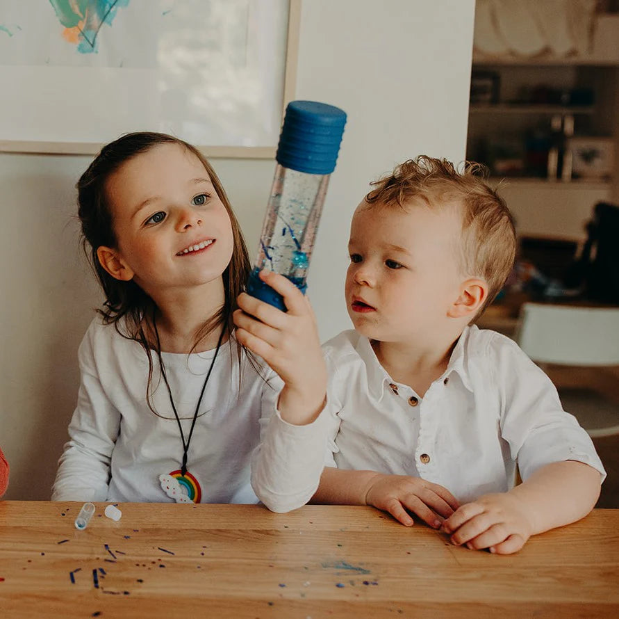Kinder schauen auf gefüllte Spielflasche